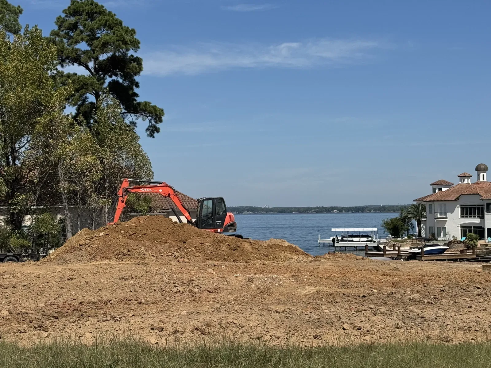 Excavator and track loader on a freshly rough-graded residential lot