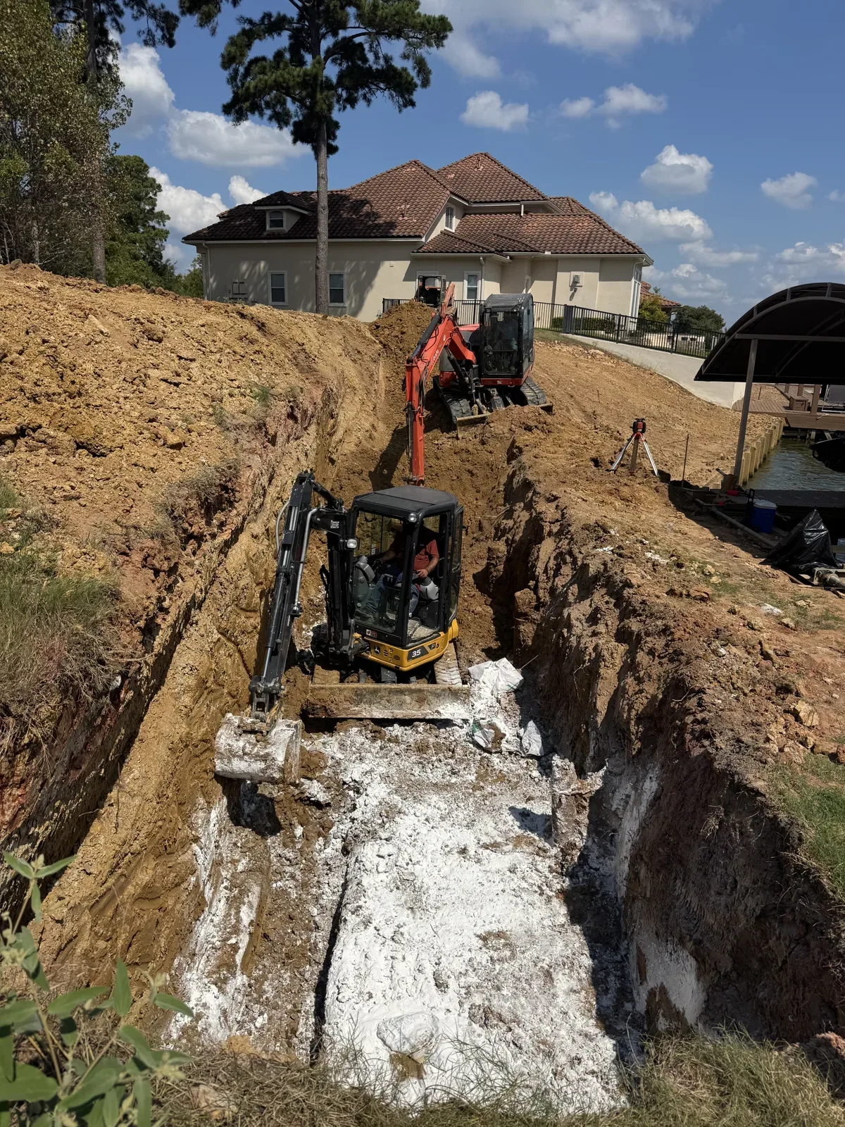 Excavated trench for a concrete retaining wall with prepared subgrade
