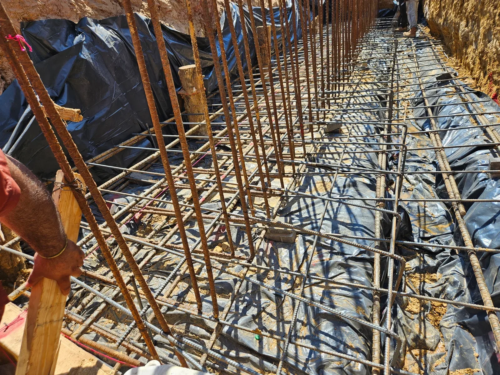 Close view of tied reinforcing steel grid with vertical dowels in a wall footing